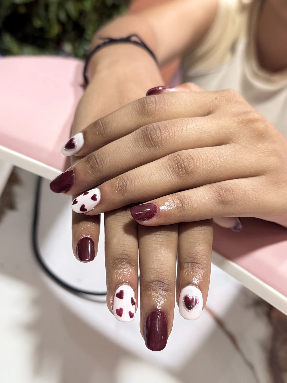 Burgundy nails with white heart accents