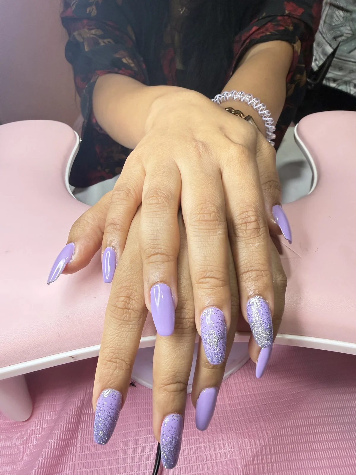 Long lilac nails with glitter accents