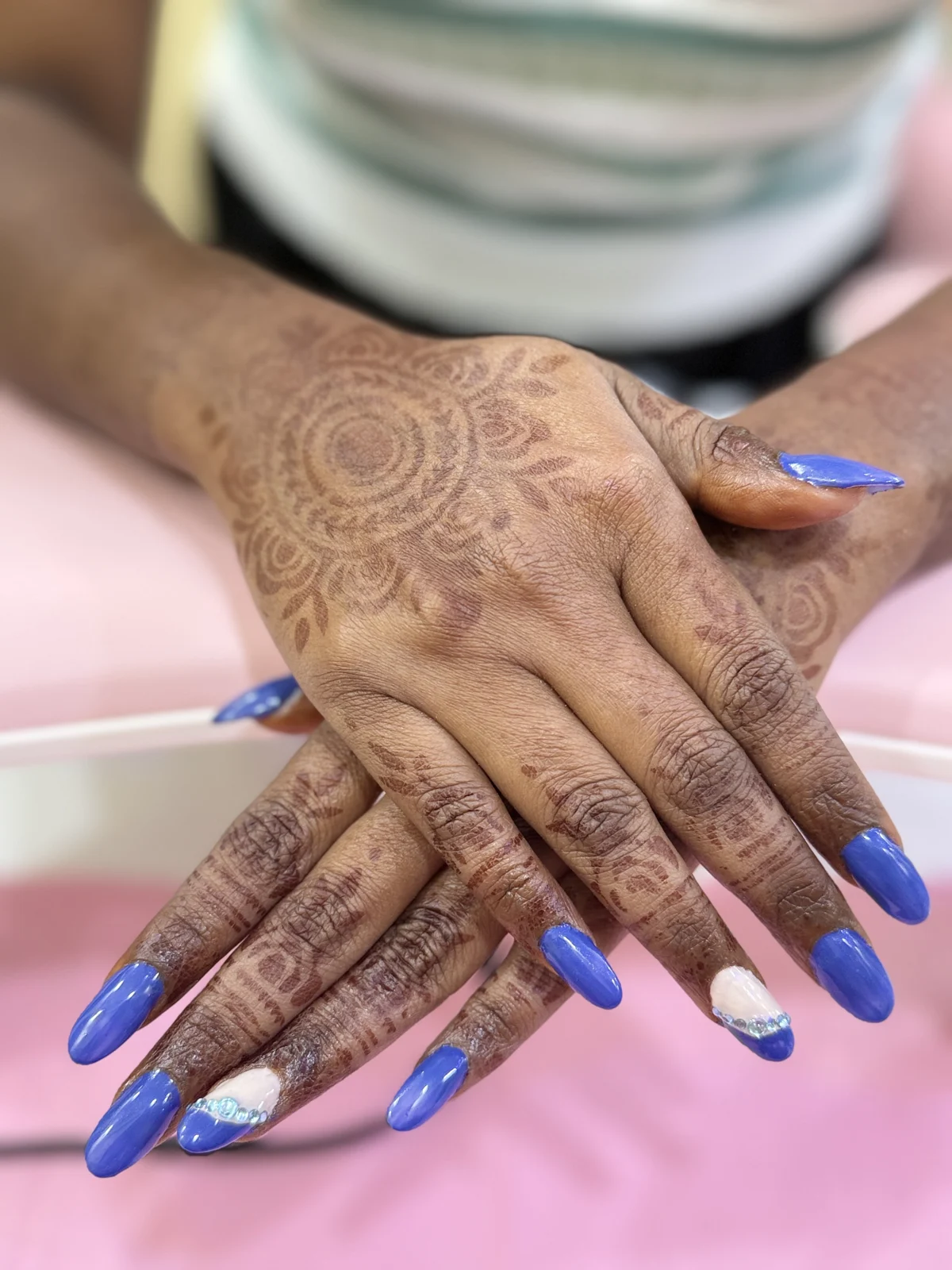 Blue nails with decorative accents and mehendi