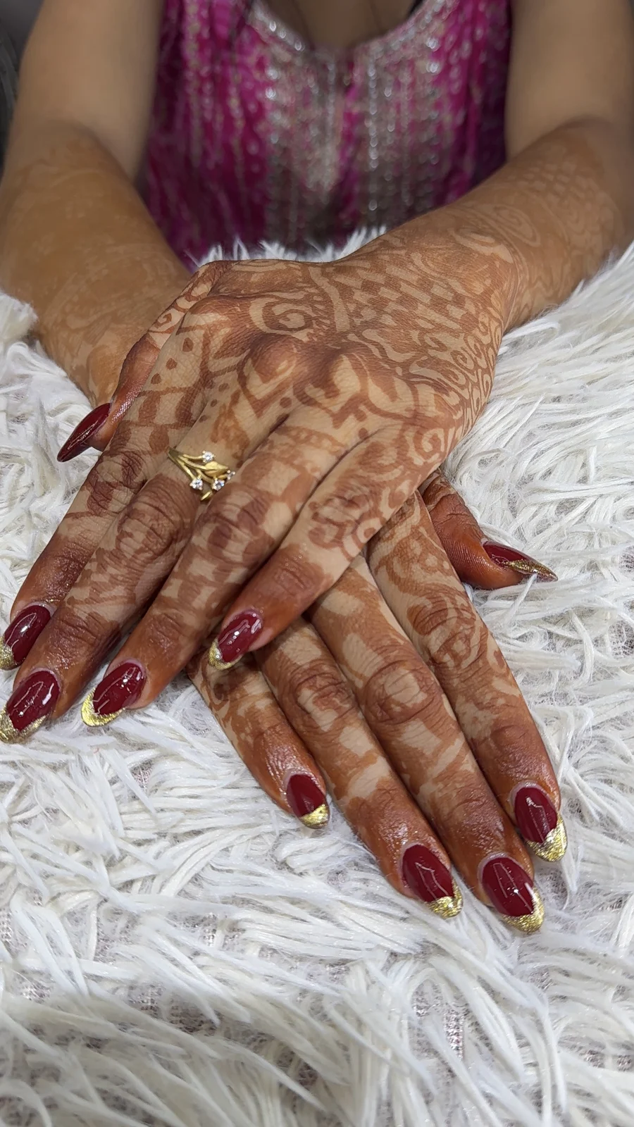 Deep red and gold nails with mehendi